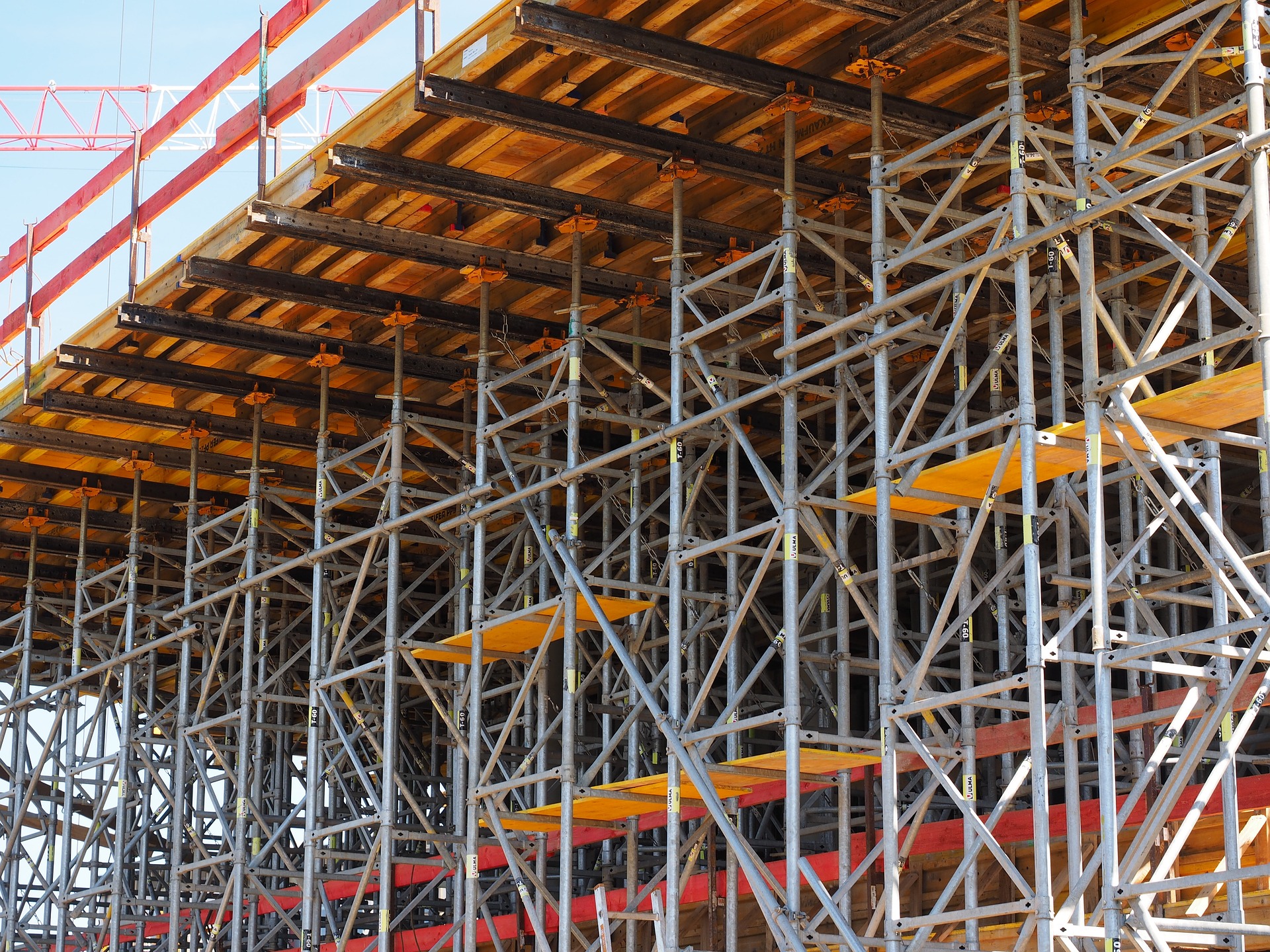 lots of scaffolding up at a construction site, hiring a scaffolding company benefits